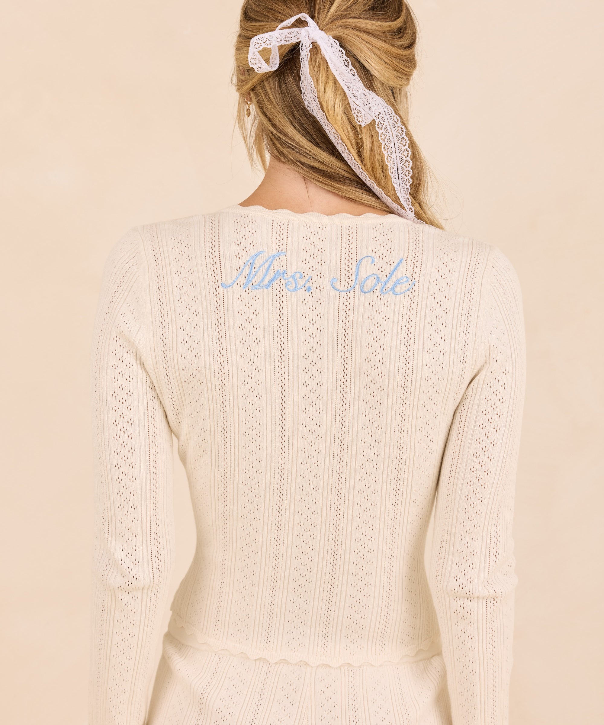 ALT's ivory Lark top seen from behind, personalized script embroidery below the neckline, over the matching Wren shorts.