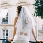ALT's white Lucinda veil with its satin bow and personalized script embroidery, seen from the side.