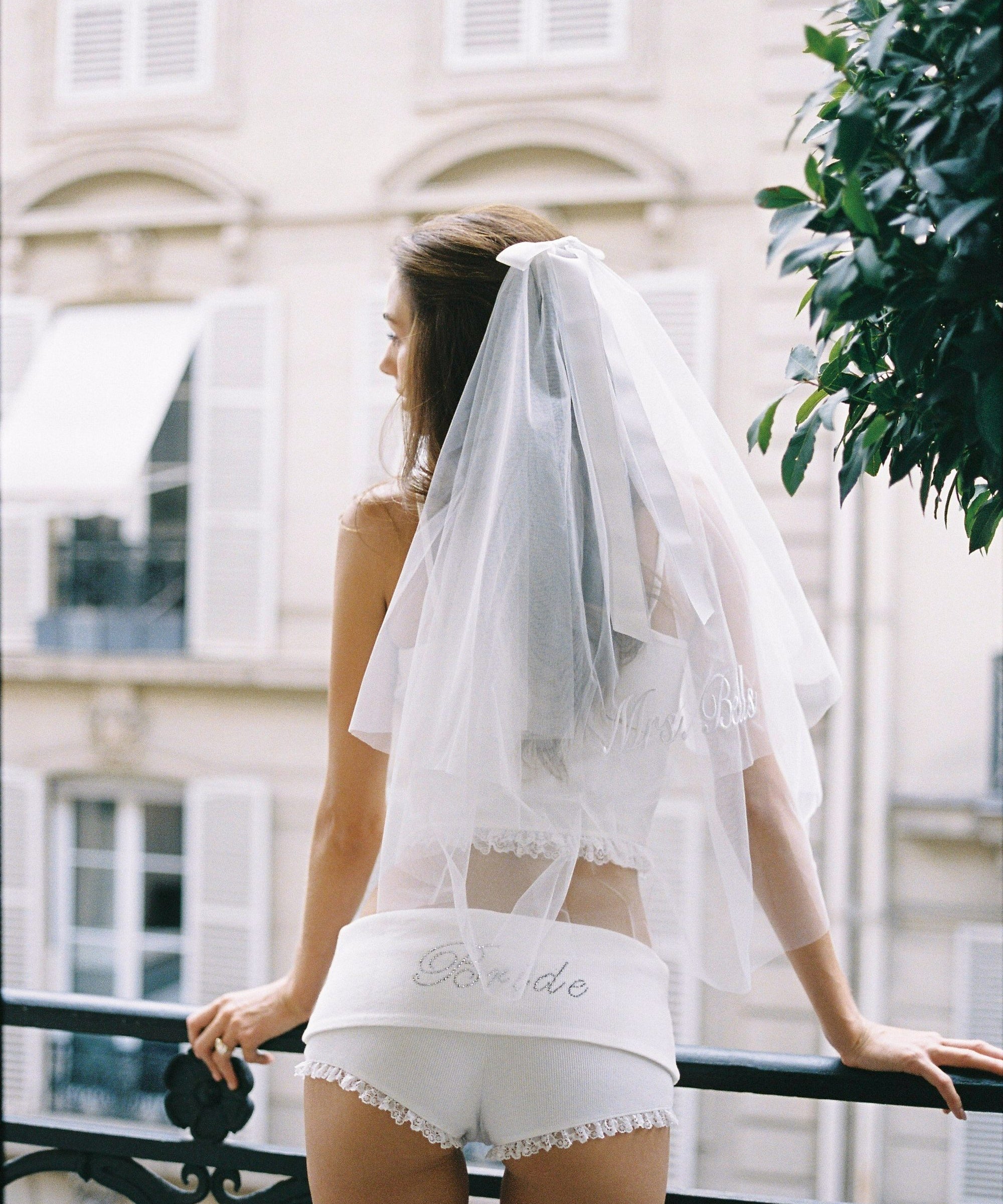 ALT's white Lucinda veil with its satin bow and personalized script embroidery, seen from the side.