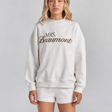 White Althea track short from the front, its drawstring waist and short hem just showing under the Pia crew sweatshirt.