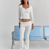 White Cleo long sleeve top in a full-length view, fitted through the sleeves and cropped at the waist, worn with the Frankie foldover ribbed pant.