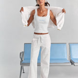 ALT's white Paola trackpant from the front, a wide straight leg to the floor with a satin ribbon tie at the elasticated waist.