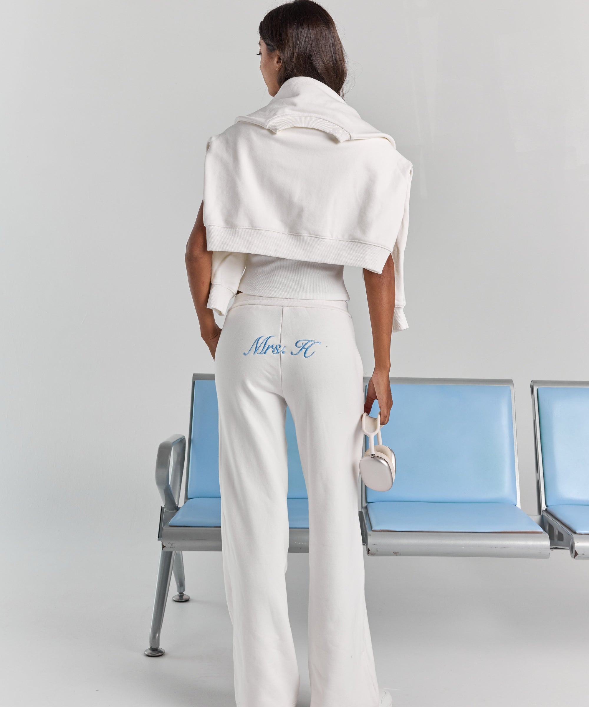 White Paola trackpant from behind, with personalized embroidery across the back below the waistband and a wide straight leg.