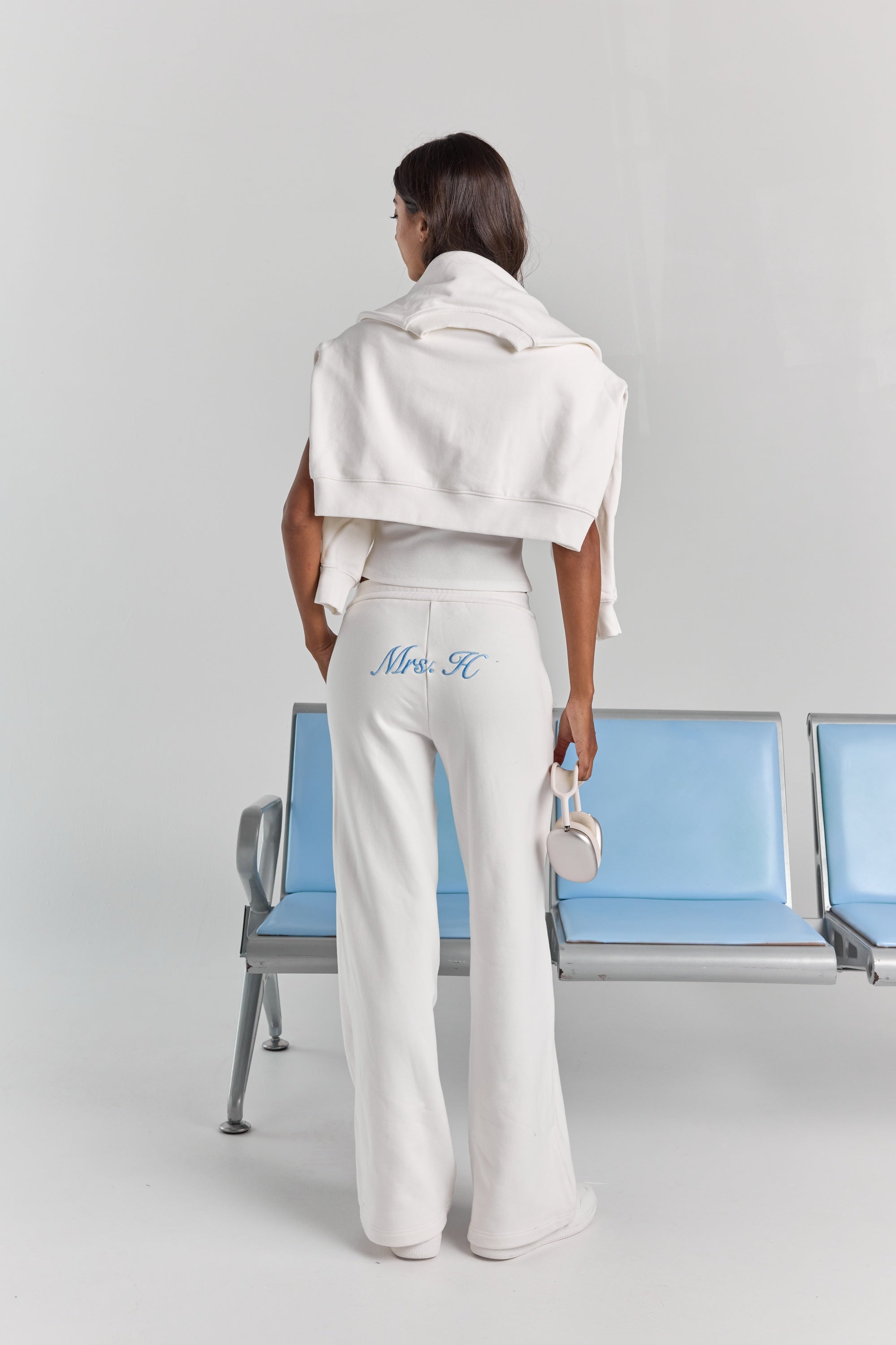 White Paola trackpant from behind, with personalized embroidery across the back below the waistband and a wide straight leg.