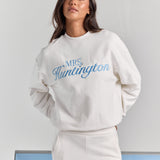 White Pia crew sweatshirt from the front, oversized through the body and sleeves, with personalized embroidery across the chest.