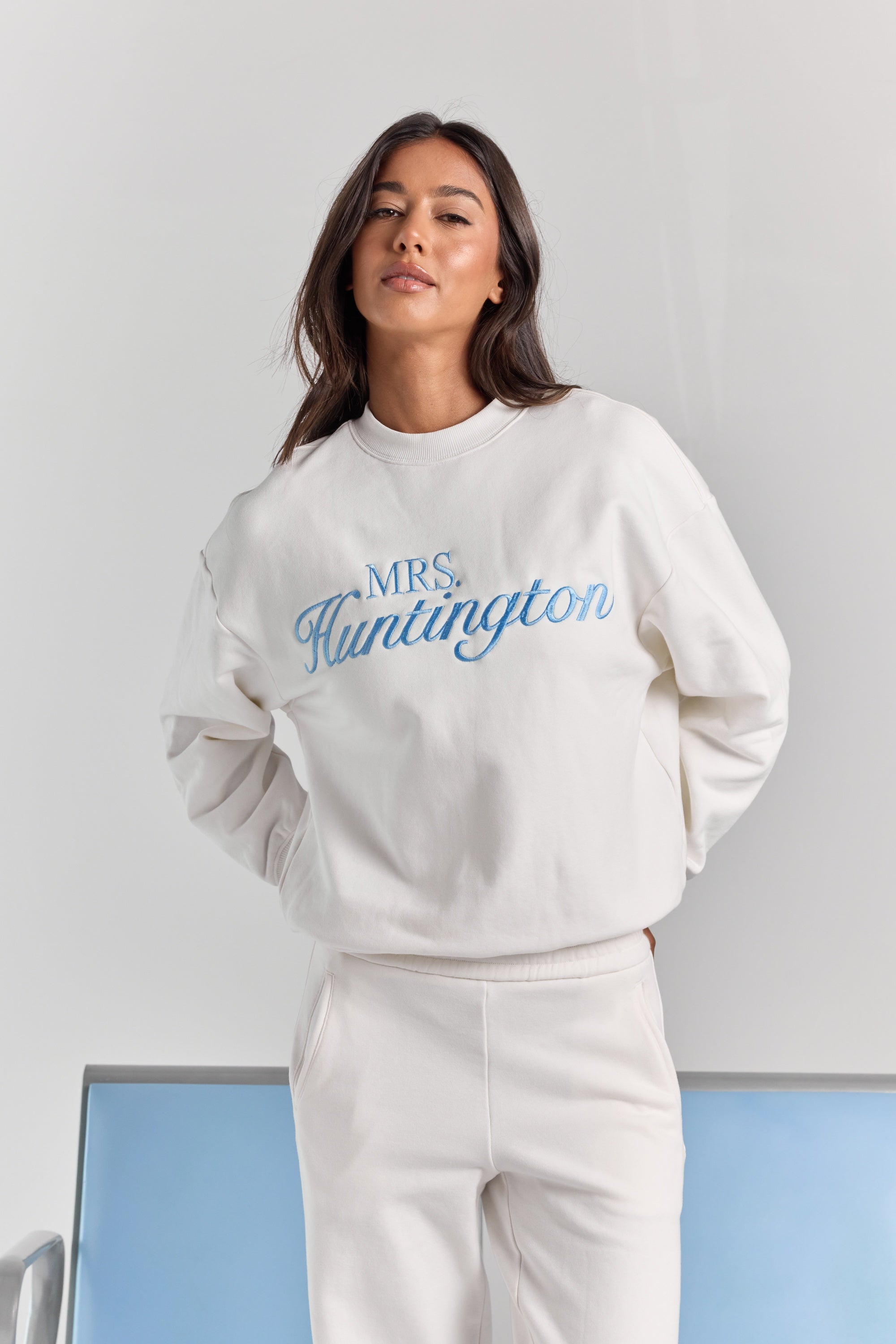 White Pia crew sweatshirt from the front, oversized through the body and sleeves, with personalized embroidery across the chest.
