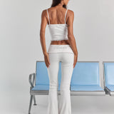 White Rhinestone Frankie foldover ribbed pant from behind, with Bride in rhinestones across the folded waistband and a flared leg.