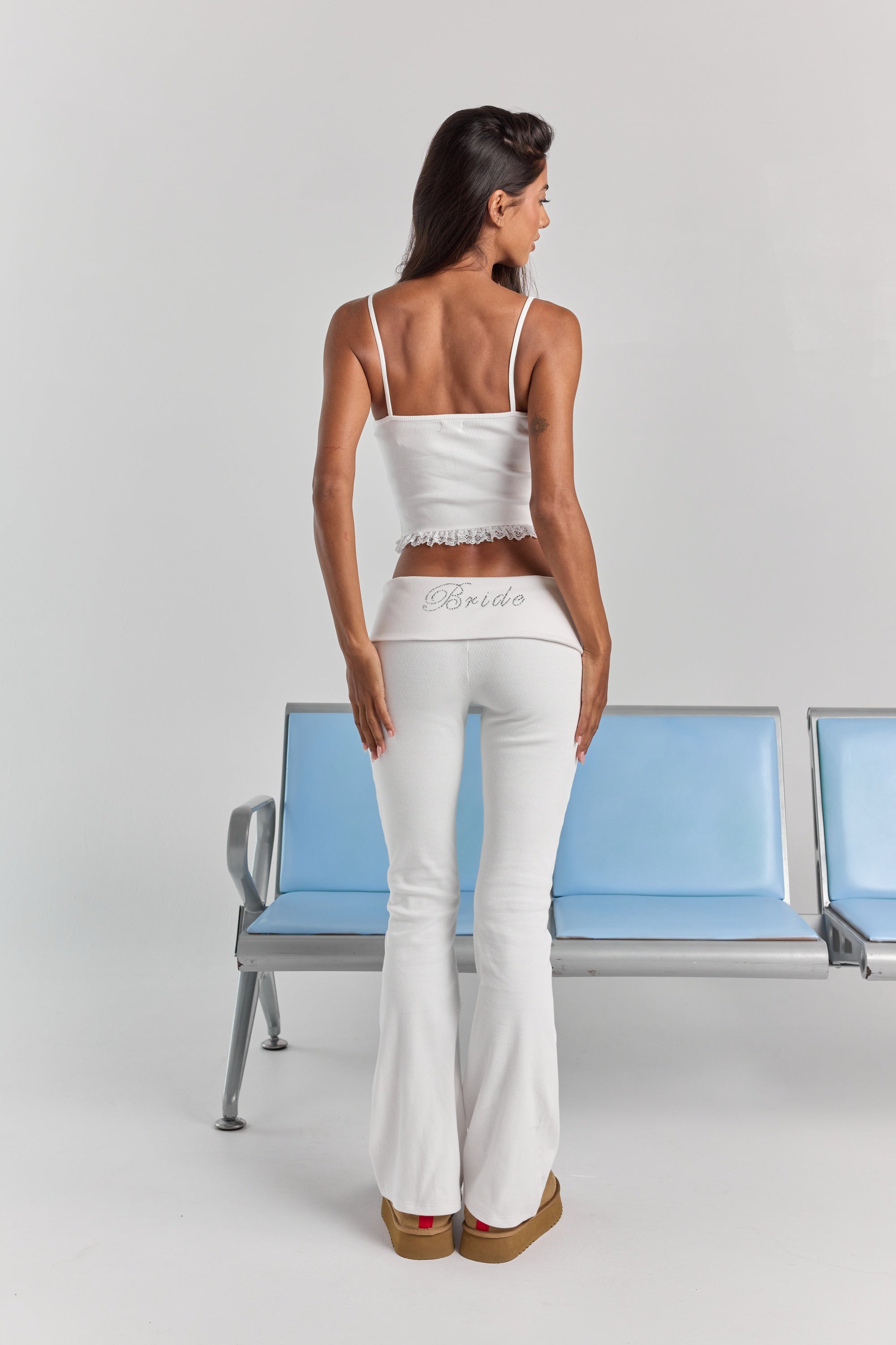 White Rhinestone Frankie foldover ribbed pant from behind, with Bride in rhinestones across the folded waistband and a flared leg.