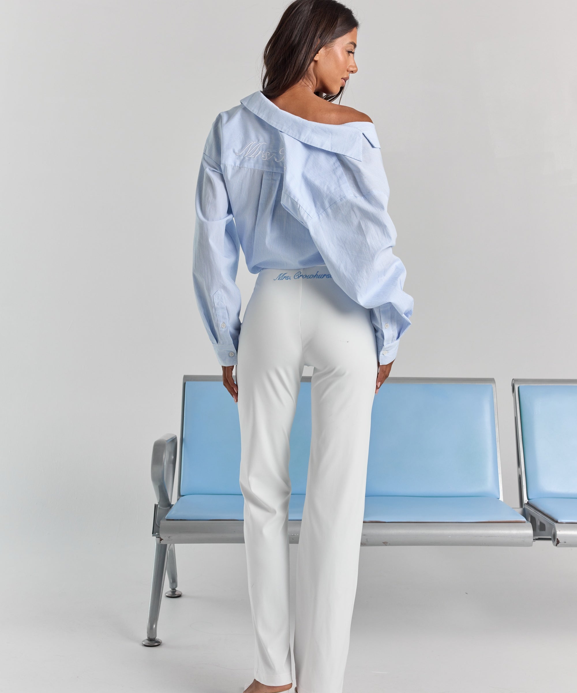 White Vivienne travel pant from behind, with personalized embroidery just below the back waistband and a straight leg.