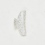 ALT's ivory Kelly claw clip, a product shot of the pearlescent face scattered with rhinestones.