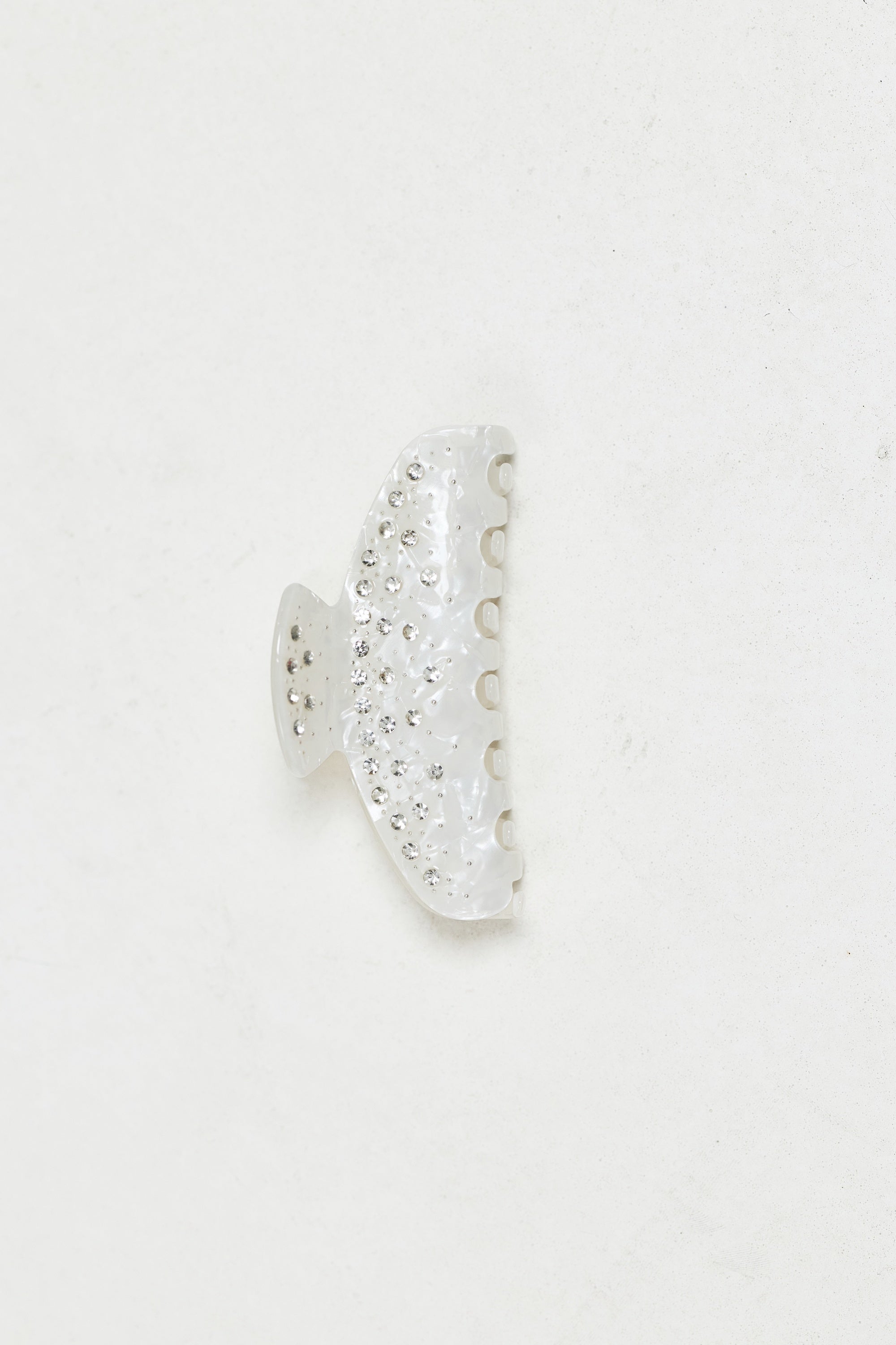 ALT's ivory Kelly claw clip, a product shot of the pearlescent face scattered with rhinestones.