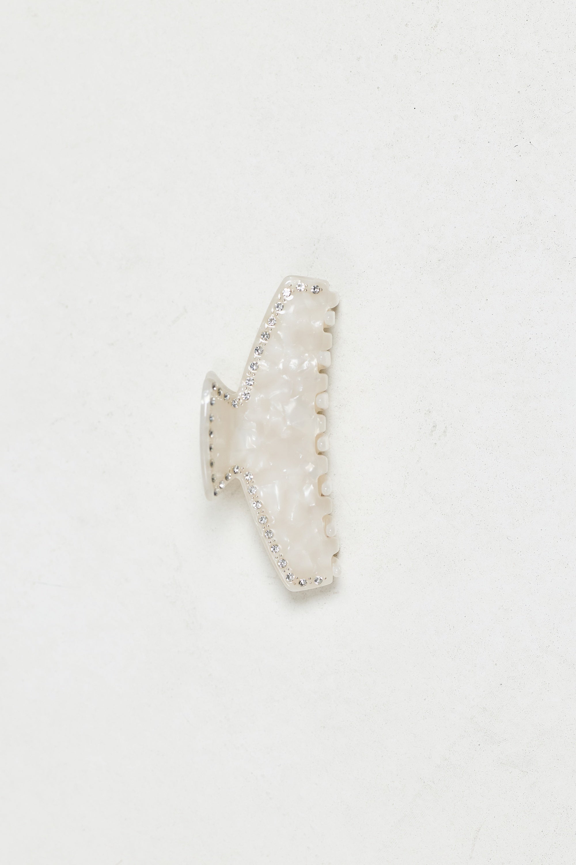 ALT's ivory Sloane claw clip, a product shot of the pearlescent clip edged in rhinestones.