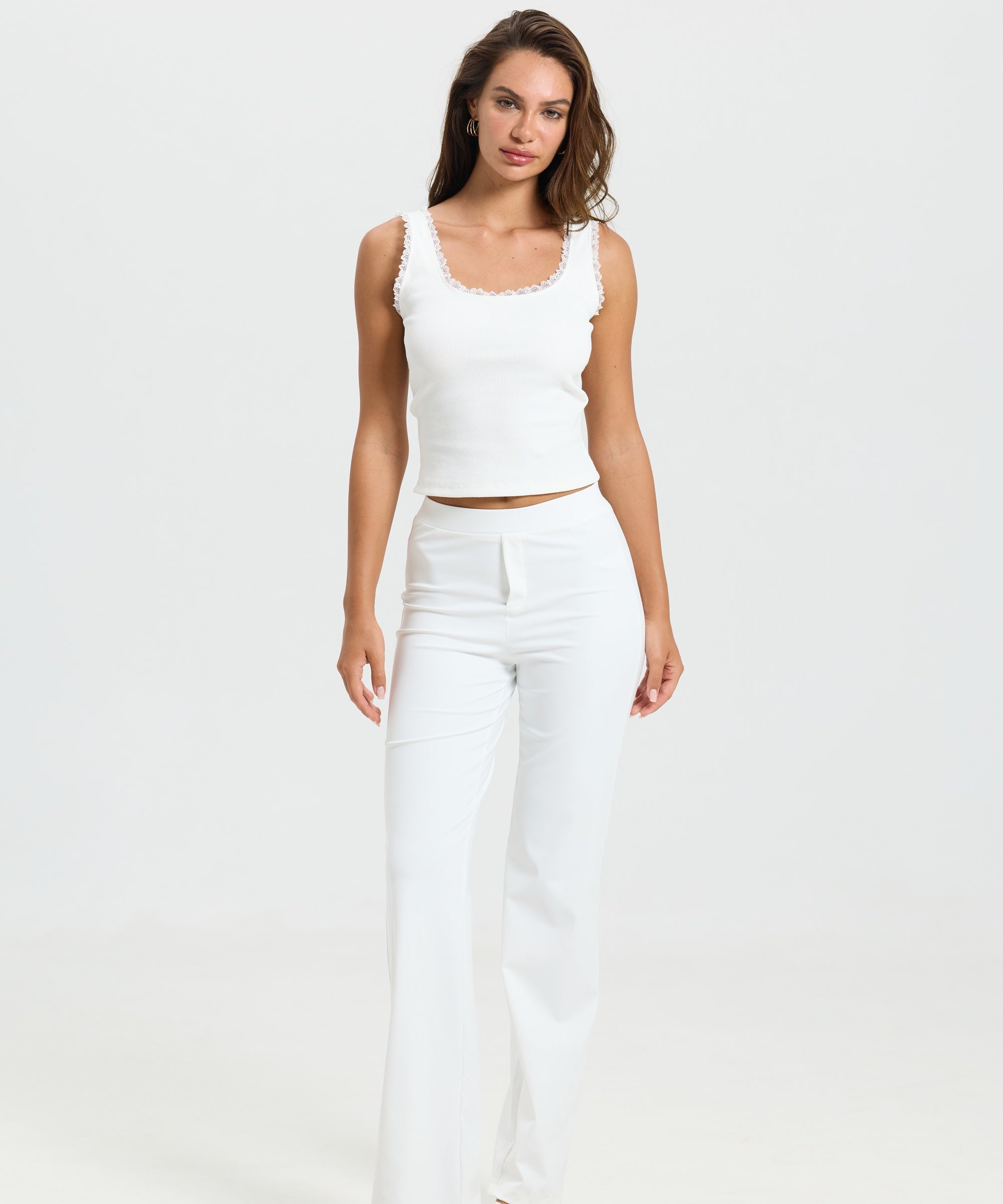 ALT's white Vivienne travel pant, shown full length from the front, the straight leg falling to the floor.