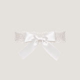ALT's white Lea bow garter, a product shot of the guipure lace band finished with an oversized satin bow.