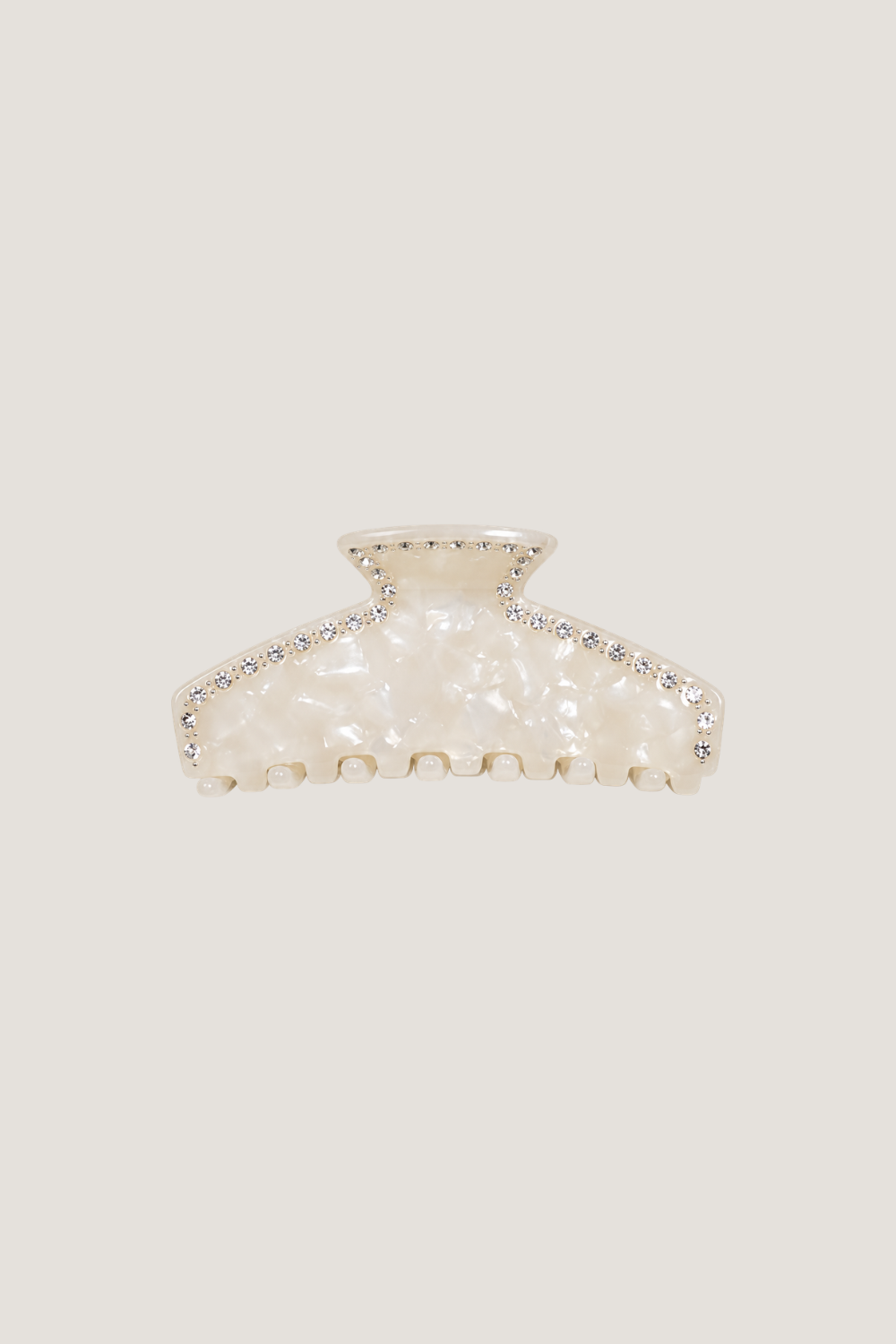 ALT's ivory Sloane claw clip, shown on its own from the front, the pearlescent body edged in a row of rhinestones.
