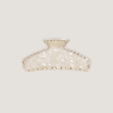 ALT's ivory Sloane claw clip, shown on its own from the front, the pearlescent body edged in a row of rhinestones.
