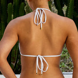 Woman wearing ALT’s Kala top and Faya bottom, a white bridal bikini set, with cacti in the background. Small satin bow and satin binding. Gold embroidery on the back of the bottoms Mrs. M