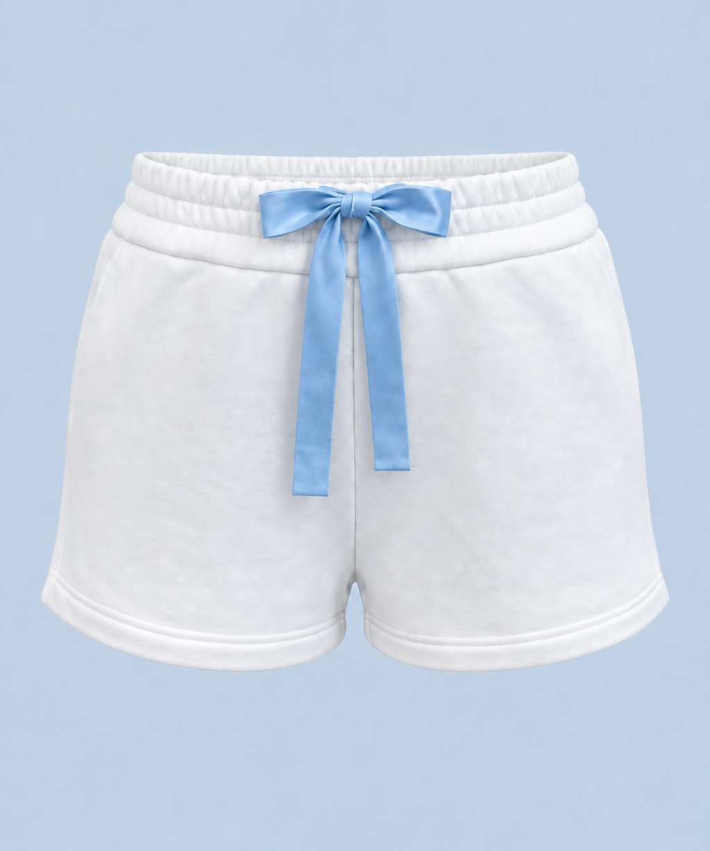 White Bride Althea track short shown on its own from the front, with a blue satin bow tied at the elasticated waist and a short hem.