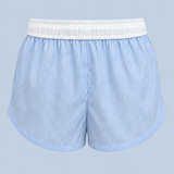 Blue stripe Beatrice drawstring short shown on its own from behind, with a gathered white waistband and a curved hem.