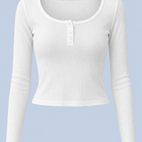 White Cleo long sleeve top shown on its own from the front, with a scoop neck, short button placket and ribbed fabric.