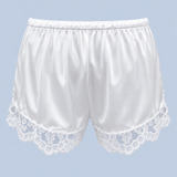 White Gianna satin lace short shown on its own from behind, with an elasticated waist and floral lace along each leg opening.