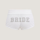 ALT's white Heiress rhinestone velour short, seen from behind on a ghost mannequin with BRIDE in rhinestones across the back.