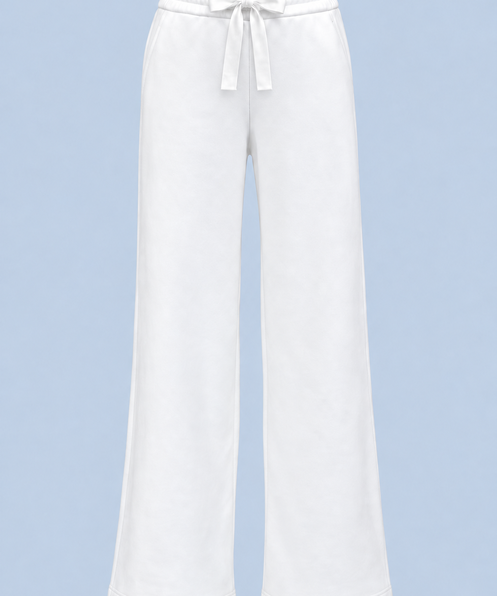 White Paola trackpant shown on its own from the front, with a satin ribbon bow at the elasticated waist and a wide straight leg.
