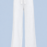 White Paola trackpant shown on its own from the front, with a satin ribbon bow at the elasticated waist and a wide straight leg.