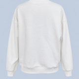 White Pia crew sweatshirt shown on its own from the back, plain with dropped shoulders and a ribbed neckline, cuffs and hem.