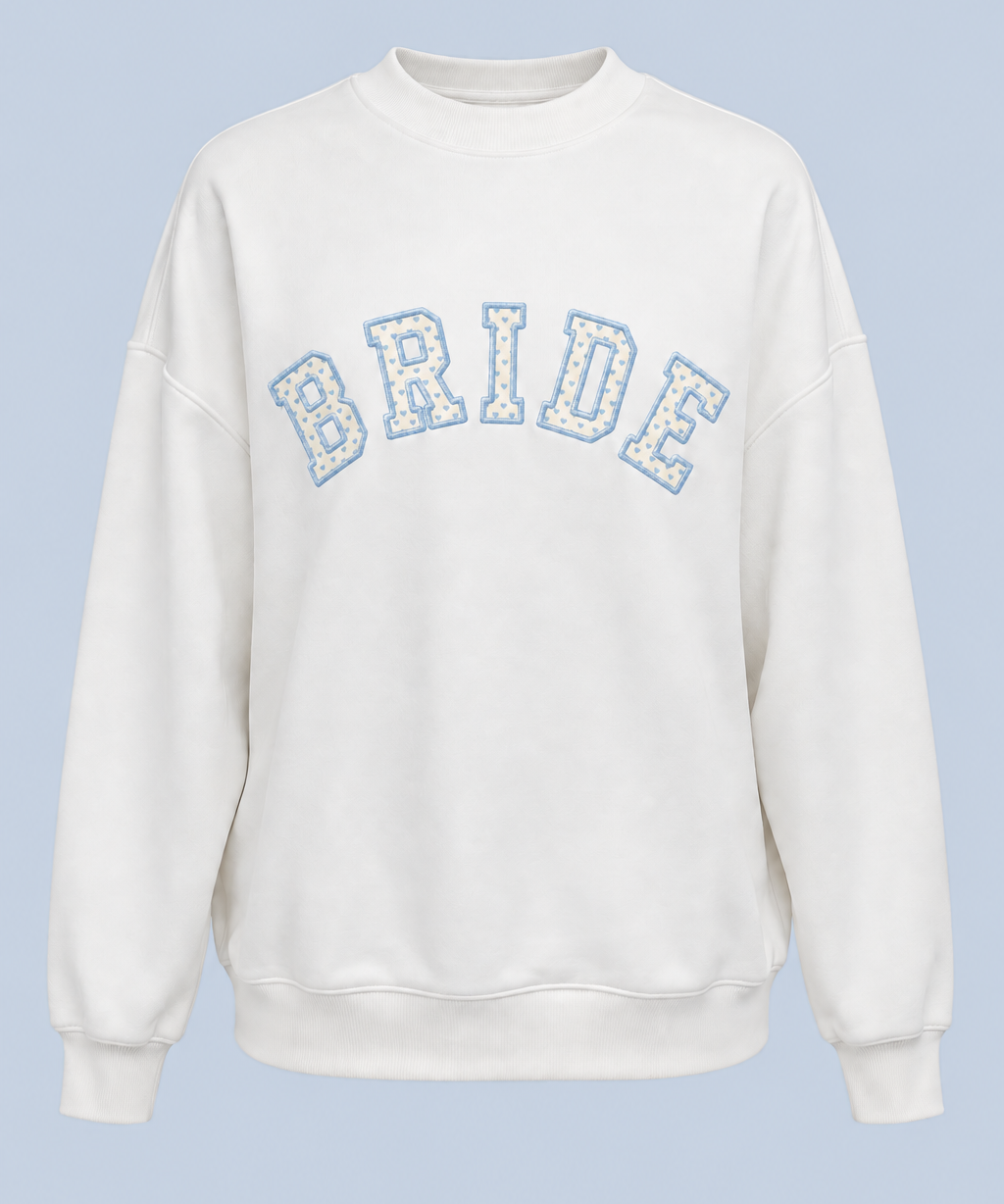 ALT's white Bride Pia crew sweatshirt shown on its own from the front, with BRIDE in blue-outlined varsity applique across the chest.